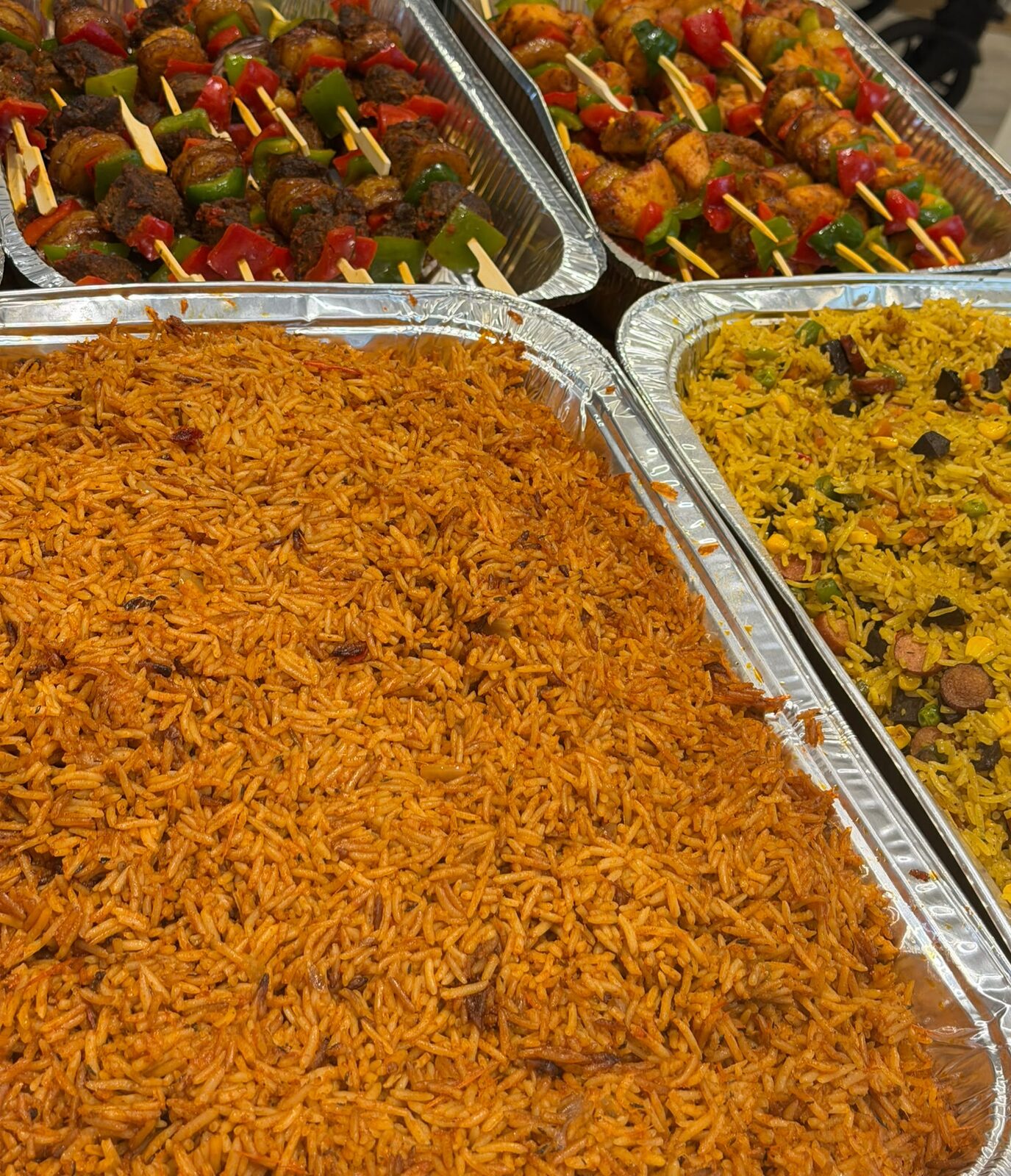Event catering trays with rice and kebabs